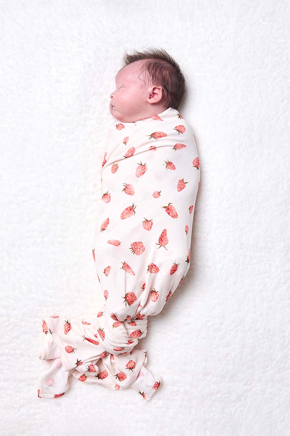 Baby in a Tula Baby Tencel Blanket Strawberry