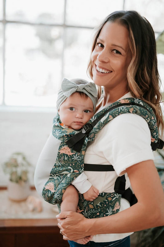 A mother an her child using the ergonomic Free-to-Grow Carrier Coast Land Before Tula.
