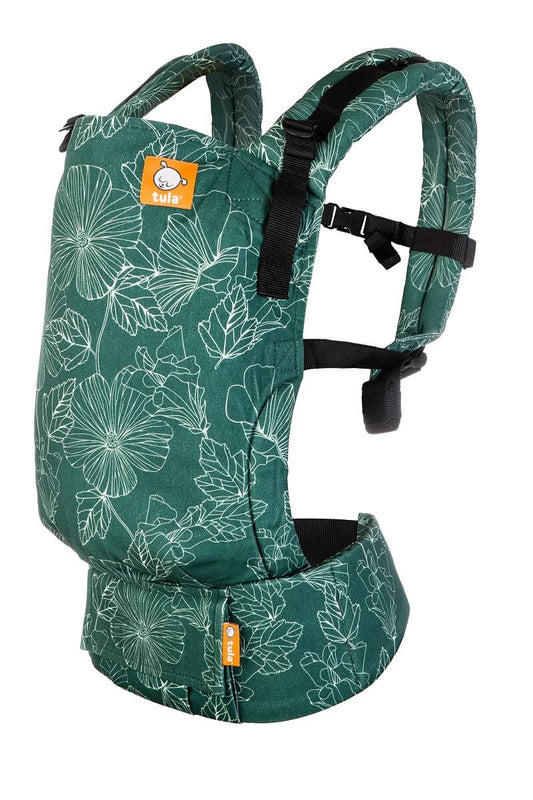Le porte-bébé ergonomique Tula Free-to-Grow Harper est orné de motifs floraux légèrement peints au pochoir dans un blanc éclatant sur fond vert forêt.