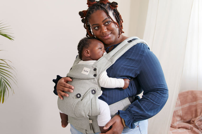 Mum carrying her child in Tula Linen Explore Spruce baby carrier