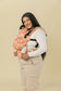 Mom babywearing and cuddling her baby in inward facing position