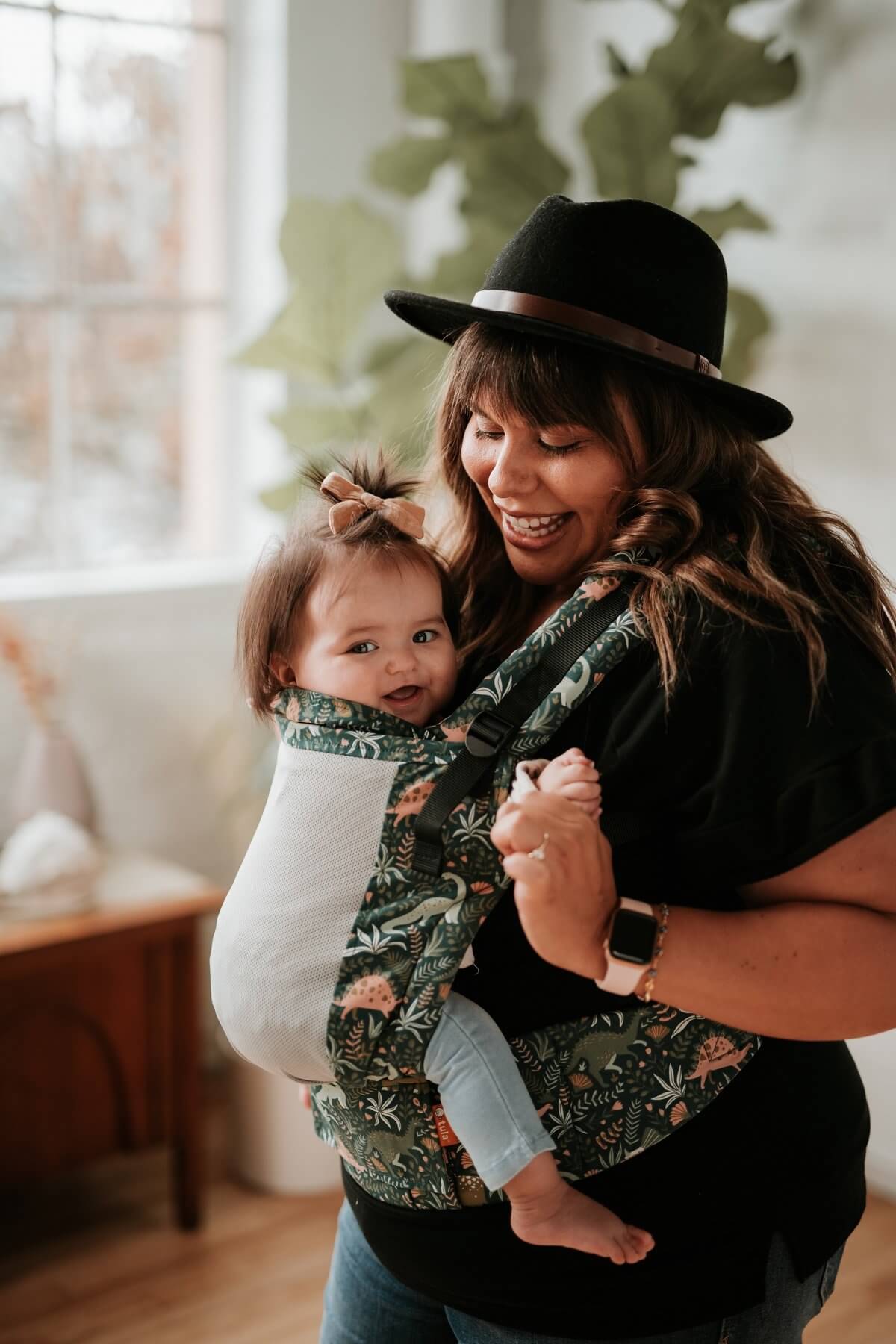 A mother an her child using the ergonomic Free-to-Grow Carrier Coast Land Before Tula in a front-carry position.