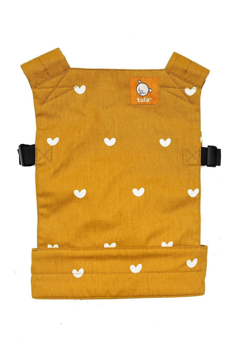 The Doll carrier Play has a design with tiny white hearts flutter across a mustard yellow background.